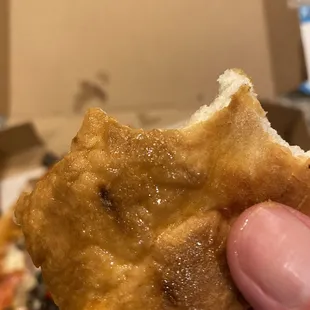 Their greasy, soaked crust olive &quot;special&quot; pizza. Bottom of the crust. Pic doesn&apos;t do it justice.