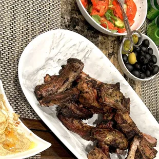 BBQ&apos;d pork ribs, Mediterranean salad, olives and hummus.