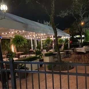 a patio with tables and umbrellas