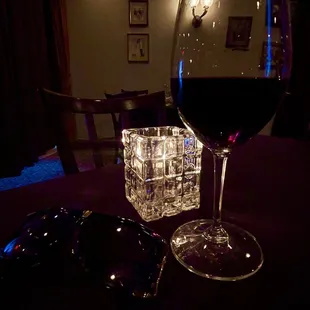 a glass of wine and a pair of sunglasses