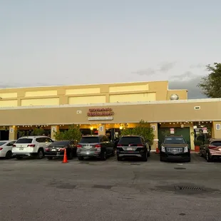 cars parked in front of a restaurant