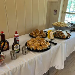 a table full of pastries and condiments