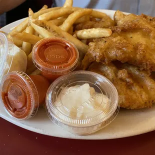 Fish fries tartar sauce and hot sauce