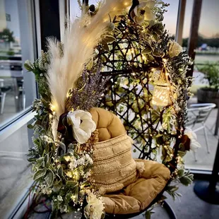 a hanging chair decorated with flowers