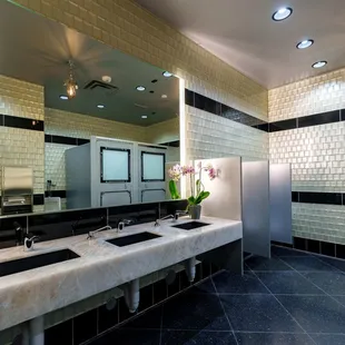 a bathroom with two sinks and a large mirror
