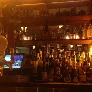 a bar with a lot of bottles on the shelves