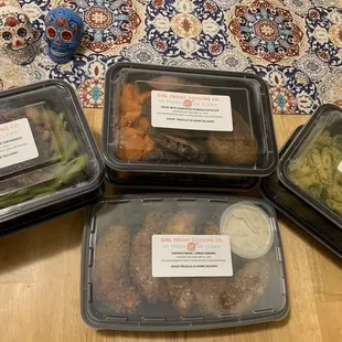 four plastic containers of food