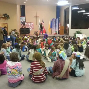 The girls are listening to a guest speaker.