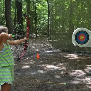 Girl Scout practicing archery at summer camp