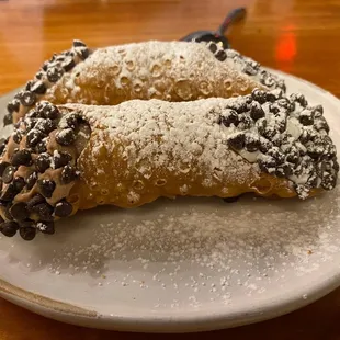 Our Canolli : sweetened whipped ricotta with chocolate chips topped with powdered sugar