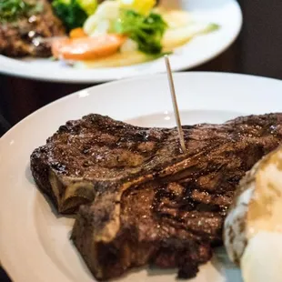 steak and potatoes on a white plate