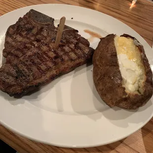 T-Bone Steak with baked potato slathered with butter and sour cream