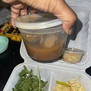 to go stewed goat container and extra pikliz cup was $1