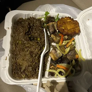 Black rice with fried goat and plaintain