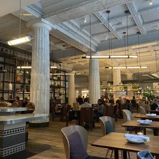 the interior of a restaurant with tables and chairs