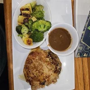 a plate of meat, broccoli, and gravy