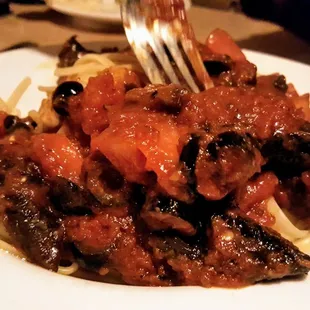 Linguine with mushroom, olives and tomato in marinara, from the specialties section of the menu