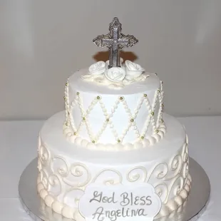 a wedding cake with a cross on top