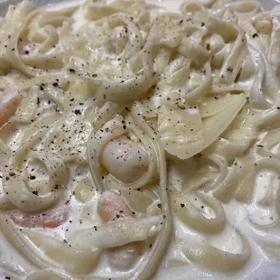 Partially eaten fettuccine Alfredo