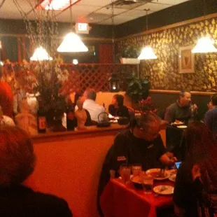 a group of people eating at a restaurant