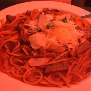 a plate of spaghetti with meat and cheese