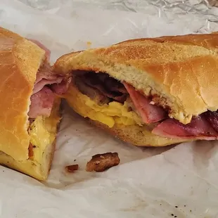 Sausage, Ham, Bacon, egg and cheese on a hero.