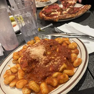 a plate of gnocchini and cheese
