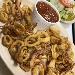 a plate of fried squids and a salad