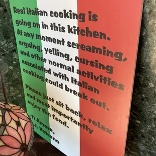 a sign that reads, real italian cooking is going on in this kitchen