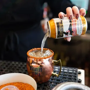 a person pouring a drink