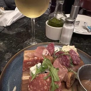 Meet and cheese board and a side of  Rislin wine. Wish I knew the name of the brand. I&apos;ve had Rislin before but this one was delish!