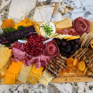A signature Give&apos; Em A Taste Catering Charcuterie Board