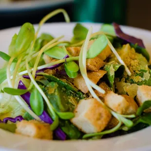 a salad with croutons and broccoli