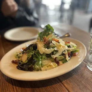 a plate of salad on a wooden table