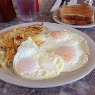 Over easy eggs with Hashbrowns and coffee.