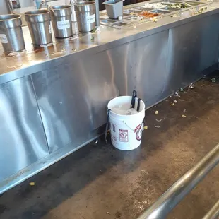 a bucket of food on the floor