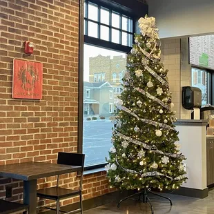a christmas tree in a coffee shop