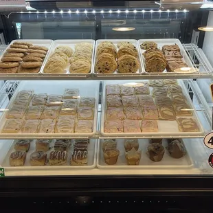 a variety of pastries in a display case