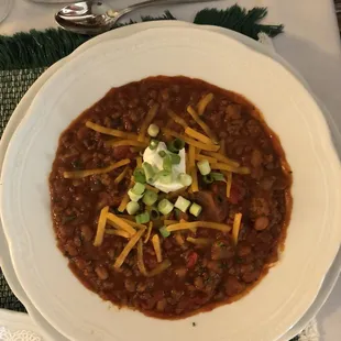 a bowl of chili and cheese