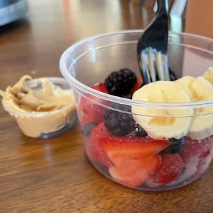 a bowl of fruit and a fork