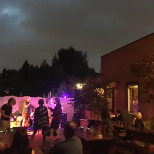 a group of people playing music on the patio