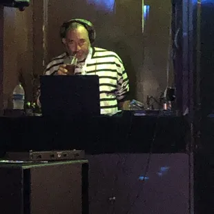  a man sitting at a table with a laptop