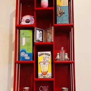 a red shelf with various items
