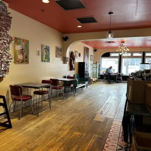 a dining area with tables and chairs
