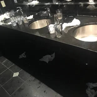two sinks in a black bathroom