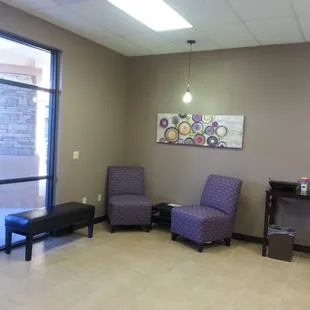a waiting room with two chairs and a coffee table