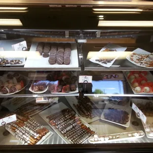 a display case with a variety of pastries