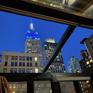 the empire state building lit in blue