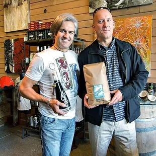 a man and a woman holding a bag of wine