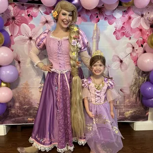 Princess Rapunzel posing with the birthday girl.